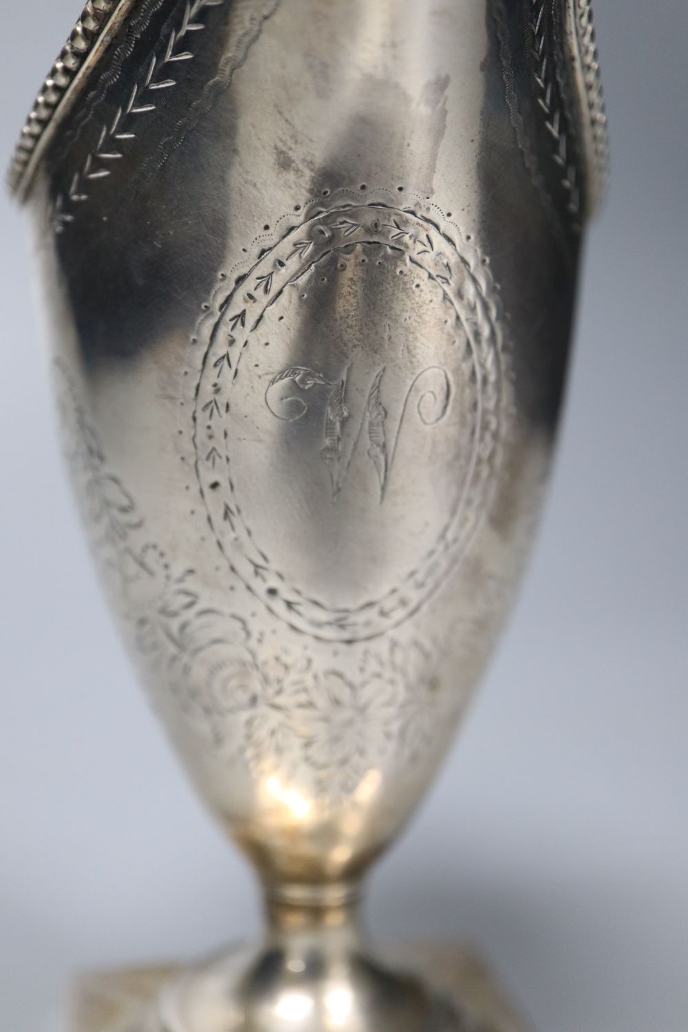 A George III engraved silver helmet shaped cream jug by Hester Bateman, London, 1785, 14.9cm, 4.5oz,